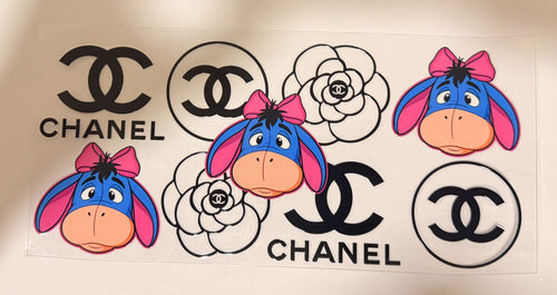 A sheet of temporary decals featuring Chanel logos and cartoon Eeyore the donkey character, shown on a plain light background.