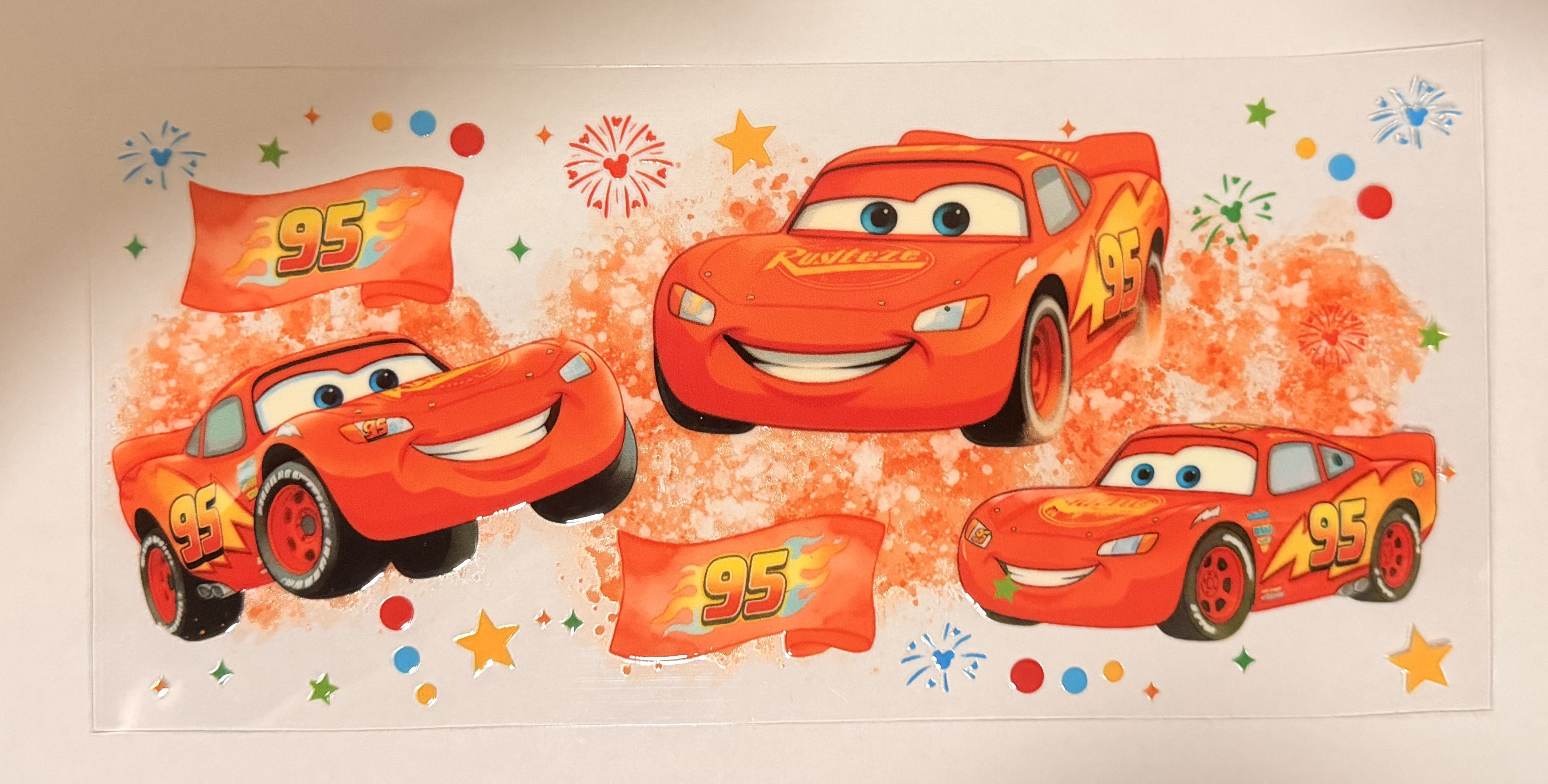 A sheet of Disney Pixar Cars Lightning McQueen wall decals featuring multiple orange-red race car illustrations, flags with '95', stars, and colorful confetti on a white background.