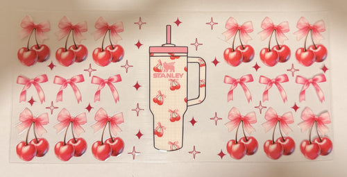 A sheet of decorative decals featuring a central Stanley tumbler illustration surrounded by repeated cherries with pink bows and small star accents on a white background.