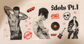A rectangular printed sticker or decal sheet featuring three shirtless male models, black-and-white portraits, red hearts, a vinyl record, a guitar, a skull with star eyes, and the text 'Idols Pt.1' and 'Born to Rock'.