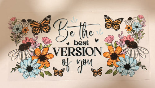A decorative printed design with the phrase “Be the best VERSION of you” in black script and block lettering, surrounded by illustrated flowers and butterflies in orange, blue, pink, white, and green on a white background.