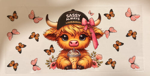 A cartoon highland cow wearing a black cap that says 'Sassy Always' and a pink bow, holding a drink, surrounded by pink and orange butterflies on a white background.