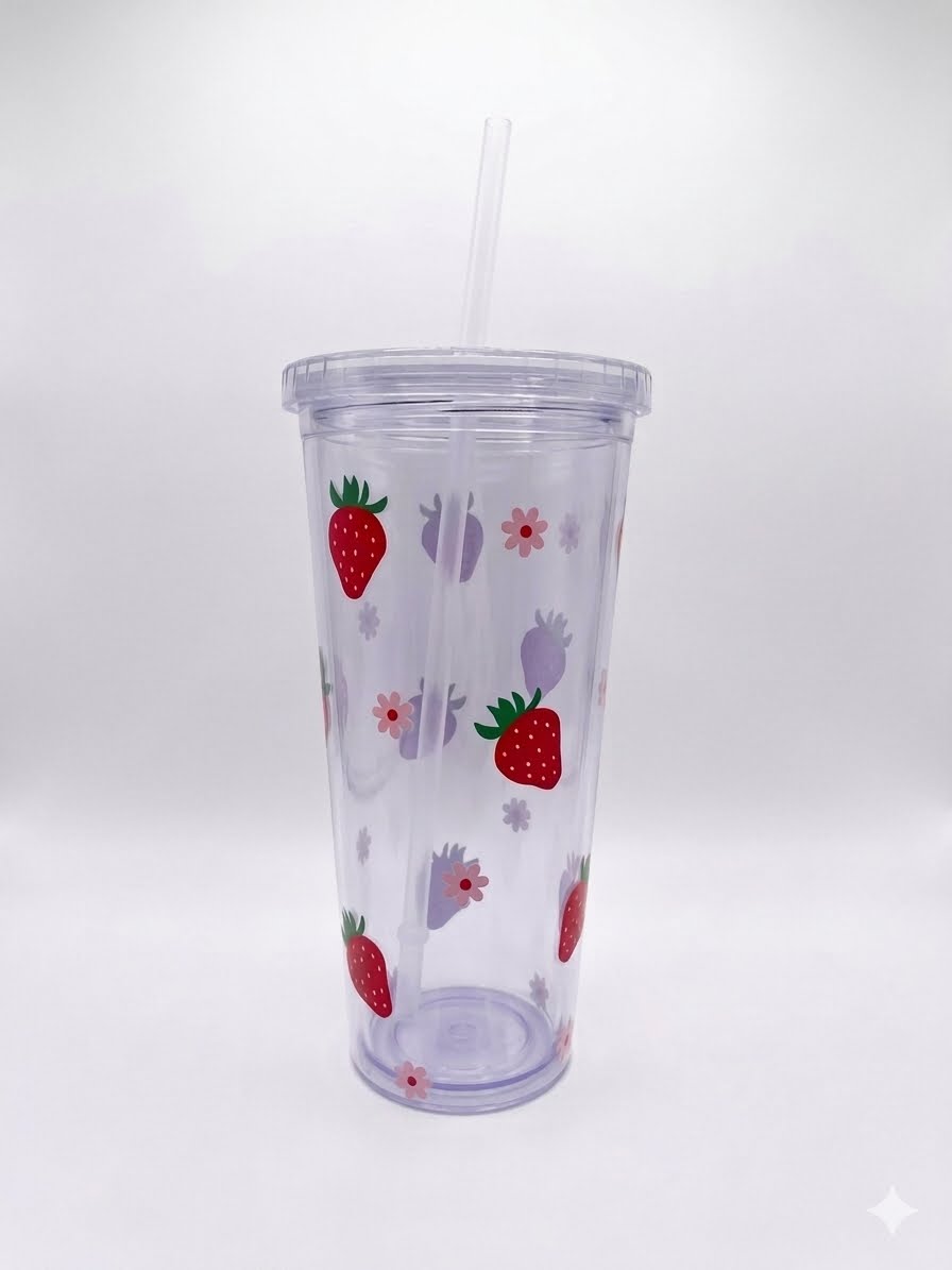 A clear plastic travel tumbler with a matching lid and straw, decorated with a pattern of red strawberries and pink flowers